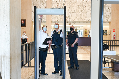 Court Officers wearing protective equipment reset magnetometers at the entrance to the Nassau County Court in Mineola, NY on Friday, May 29, 2020