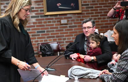 Photo of a Family Court Judge with young children being adopted