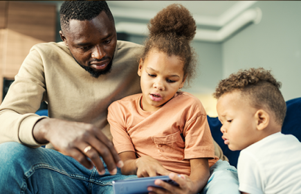Photo of adult man with two young children