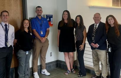 Drug Court Team posing with Onondaga County PO and Drug Court Peer with Onondaga County Public-Access Naloxone Box.