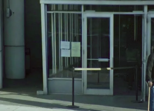 Description of photo: A double door entrance located on street level. The door to the right is open.