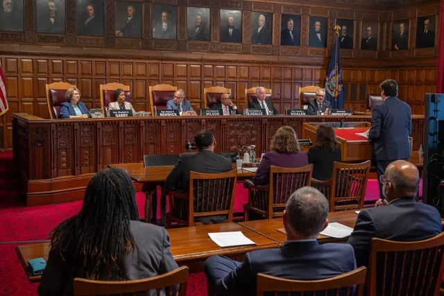 Fordham Law School Professor and Dean Emeritus Matthew Diller addresses the Chief Judge’s Civil Legal Services Hearing at Court of Appeals Hall in Albany. On the panel are (L-R) Presiding Justices Elizabeth Garry and Dianne Renwick, Chief Judge Rowan Wilson, Presiding Justices Hector LaSalle and Gerald Whalen, and New York State Bar President Domenick Napoletano. 