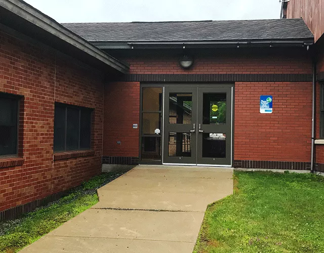 Description of photo: Hamilton County Court Offices inc. Surrogate, Family, County with a walkway that leads to a set of double doors.
