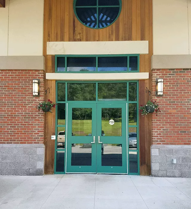 Description of photo: Hamilton County - Courthouse Jury Office has a set of double doors accessed from the sidewalk. To the left and right of the doors are hanging flowerpots