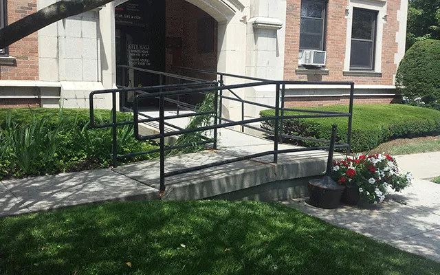 Description of photo: There is a ramp to the left of the lawn that leads to the entry way.