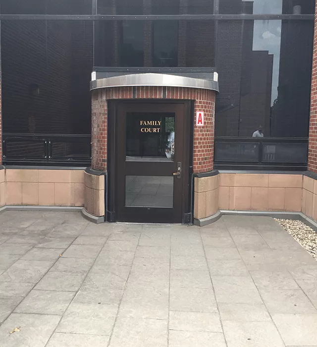 Description of photo: A single door entrance to Family Court. The door is accessed directly from the sidewalk.