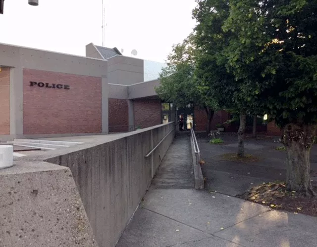 Description of photo: A long ramp leading to the court facility. The building has 'Police' posted on the side of the building.
