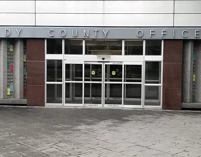 Description of photo: A set of automatic doors that are accessed directly from the sidewalk.