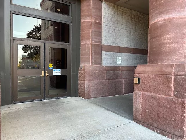 Description of photo: A set of automatic doors that are accessed directly from the sidewalk.