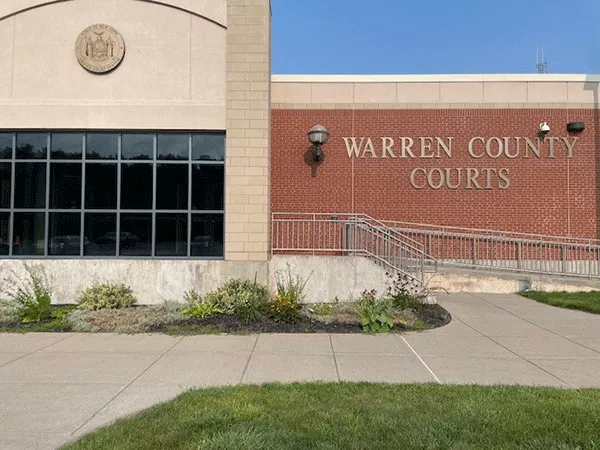 Description of photo: Warren County Court Facility. A ramp can be accessed from the far right that will lead to the entrance door.