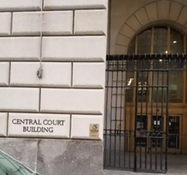 The entrance to the Central Court Building. The entrance doors are accessed from street level through the metal gate.