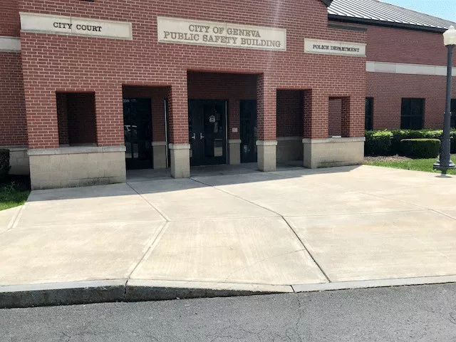 An enclosed entry way accessed directly from the sidewalk through a set of double doors.