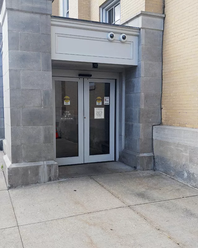 Two automatic sliding doors that are accessed from the sidewalk.