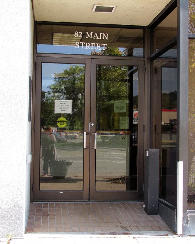 A set of double doors to the court facility. There is pole with a push button on the right side.