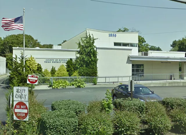 A complete view of the court facility. The entrance is accessed through the parking area. There is a ramp on the far left side of the building.