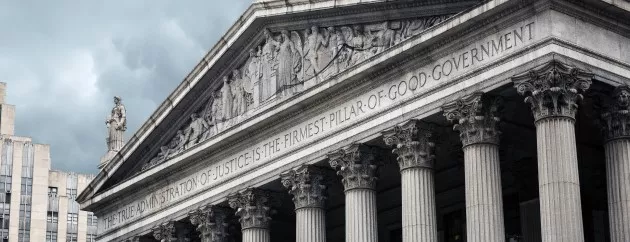 Photo of courthouse with "THE TRUE ADMINISTRATION OF JUSTICE IS THE FIRMEST PILLAR OF GOOD GOVERNMENT" engraved into the building's facade.