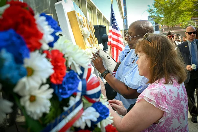  Photo: Many people stopped to place flowers at the court system’s 9/11 memorial at 111 Centre Street