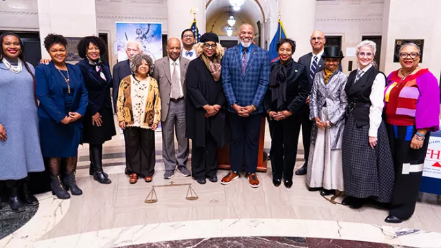 Commission members and guest speakers pose for a group photo 
