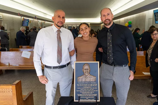 The late Judge Ruben Martino’s sons Ruben (left) and Eric (right) and granddaughter Nilah at the Bronx Family Court’s courtroom dedication ceremony in early October 