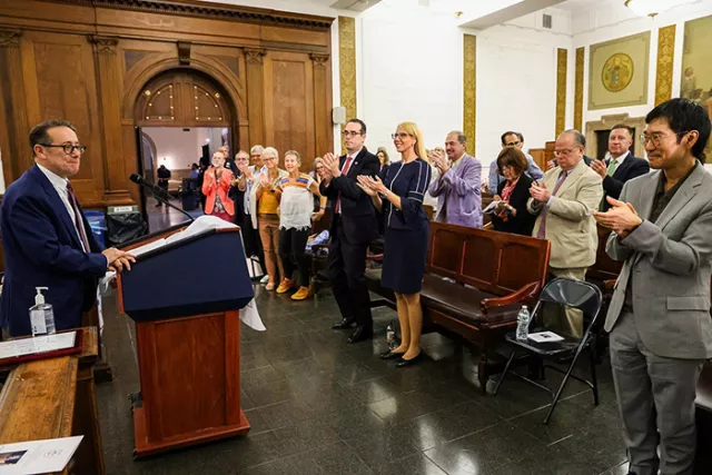 Honoree Jeffrey S. Trachtman receives a heartfelt standing ovation during the June ceremony.