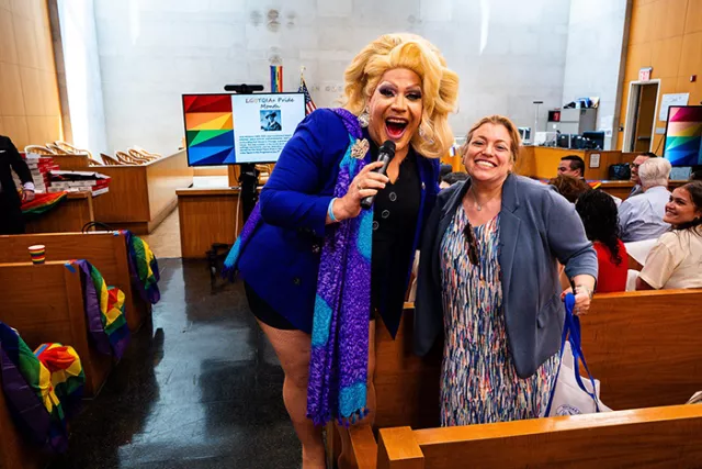 Principal Court Attorney Beth From receives a Bingo prize from drag performer Porsche at the Jamaica, Queens court’s Pride celebration 