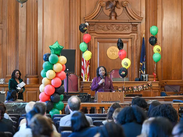 Administrative Judge Grays introduces award-winning journalist Cheryl Wills, who emceed the event