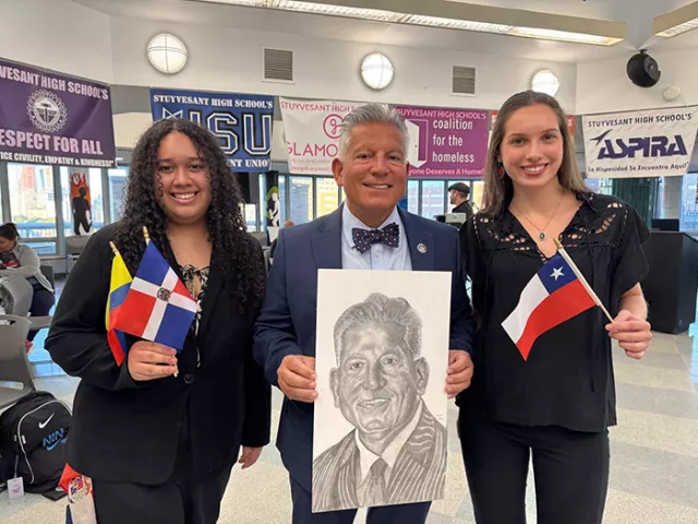 Chief Administrative Judge Joseph Zayas with Stuyvesant High School students at the school's annual Hispanic Heritage Dinner in Lower Manhattan. Judge Zayas is holding a portrait sketched by a Stuyvesant High School student and presented to the judge at the event.