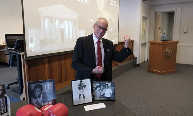 Photo: Suffolk County District Court Judge Eric Sachs stands behind the display at the Suffolk County Courts’ salute to sports and civil rights icon Muhammad Ali in Central Islip 