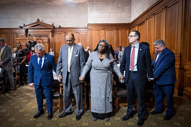 Judges Zayas, St. George, Richardson and Silvera and District Attorney Gonzalez join hands during the closing benediction at the Second Department's William C. Thompson Sr. awards ceremony 