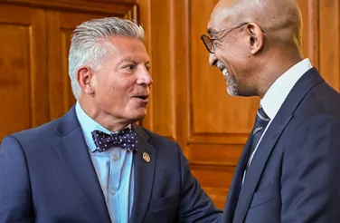 Photo of two male attorneys chatting
