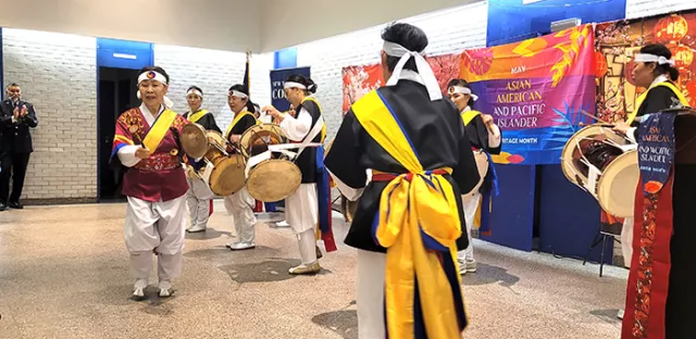 Members of the Korean American Senior Citizens Society of Greater New York were among the performers at the Bronx County Family Court’s lively AAPI celebration. Pictured left is Major Henry Chen, who opened and closed the cross-cultural program.