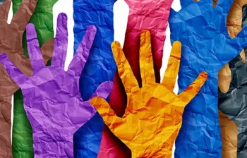 Photo of bright colored paper cut-outs in the shape of hands reaching up.