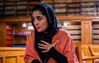 Photo of a woman inside a law library.