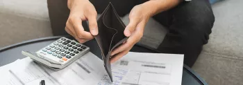 Photo of a hands opening an empty wallet.